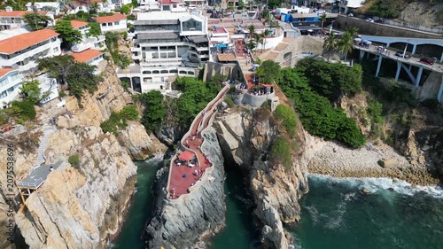Spectacular drone video capturing the famous La Quebrada cliffs and ocean views in Acapulco, Mexico. Iconic tourist destination with impressive natural beauty.