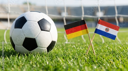 Close Up of Classic Soccer Ball with Miniature Germany and Paraguay Flags on Pitch Background