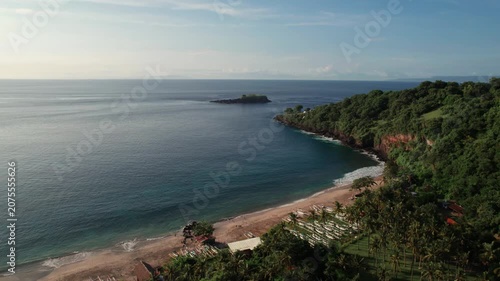 Aerial View of Virgin Beach Bay with Palm Trees, Traditional Boats, Green Cliffs and Blue Ocean in Bali