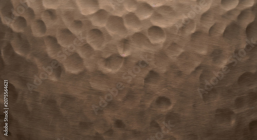 Hand hammered matte bronze metal texture with wabi sabi dimples