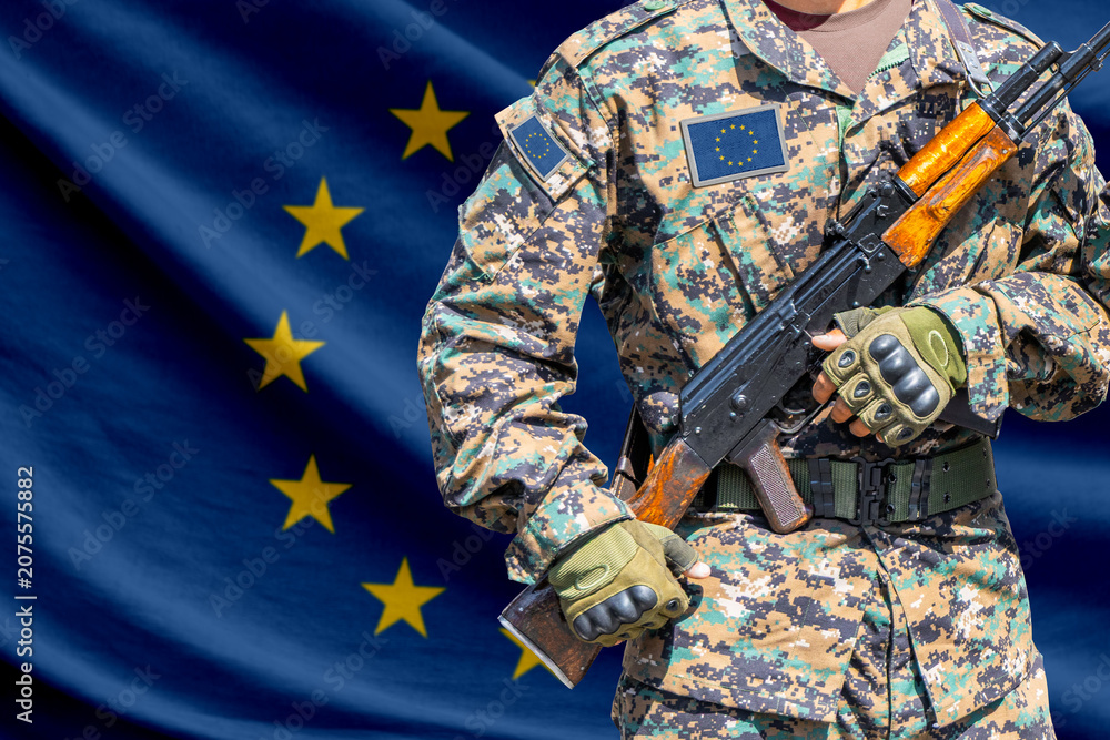 Fototapeta premium European union flag with soldier holding assault rifle