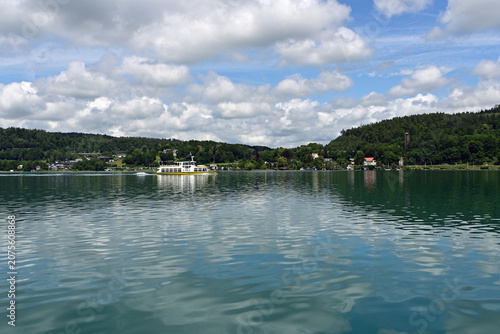 Принти на полотні View of placid Lake Worthersee near Klagenfurt, Austria with summer cloudscape reflected in calm water