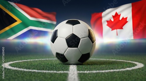 Soccer ball on green pitch between South Africa and Canada flags, international match concept, stadium lighting background.