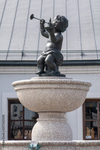 Bronze cherub statue on stone fountain