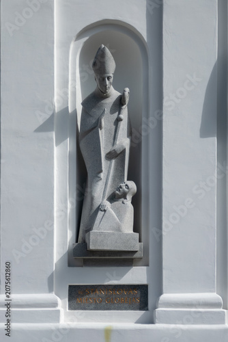 Saint statue on white church facade