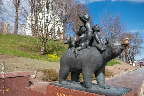 Bronze bear statue with children in park