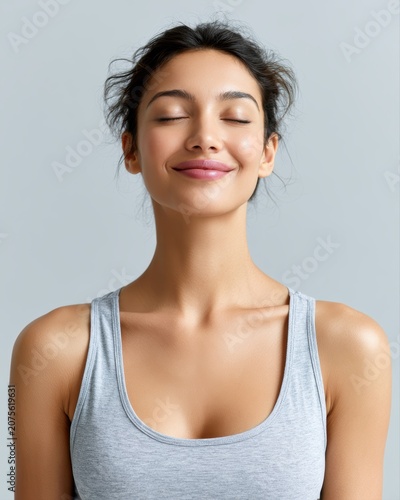 Young woman smiling after completing morning meditation session, mindfulness concept