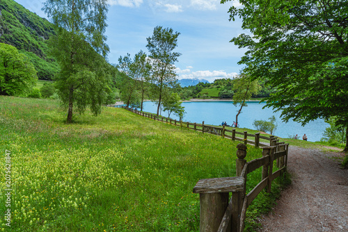 The view of Lake Tenno, a splendid alpine lake nestled between mountains and woods, near Lake Garda, near the town of Tenno, Trentino, Italy - May 2026