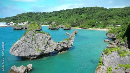 Aerial view of rock cliffs in the turquoise sea, Okinawa, Japan.