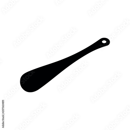 Black silhouette of a long plastic shoehorn with a hole for hanging storage