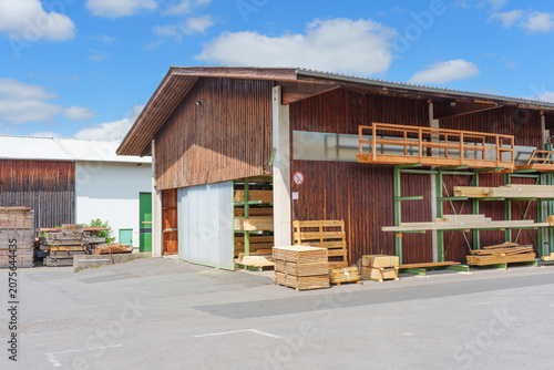 Exterior Of Industrial Wood Storage Warehouse With Timber Racks