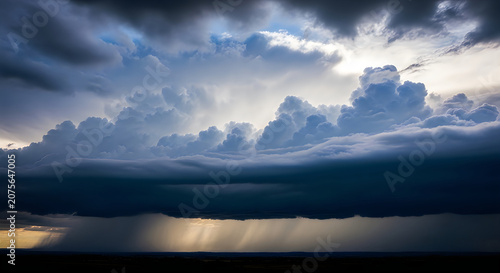 Dramatic Sunset Over Calm Water with Stormy Clouds and Golden Light Reflection