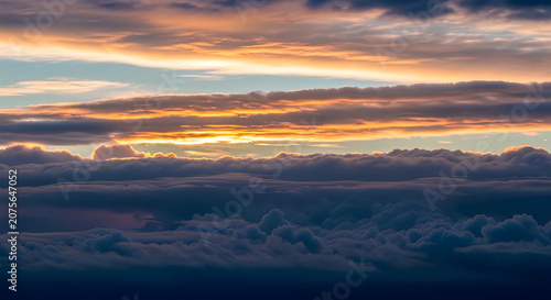 Dramatic Sunset Over Mountain Range with Clouds and Golden Light