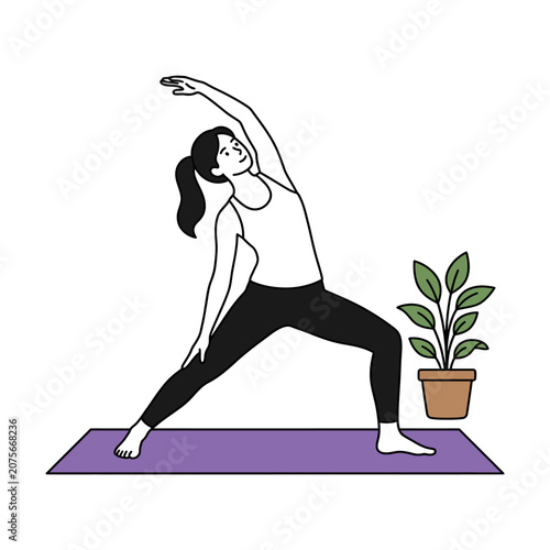A woman performs a yoga pose on a mat in a room