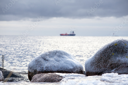 Oil tanker sailing at winter near Frozen Coastal waters