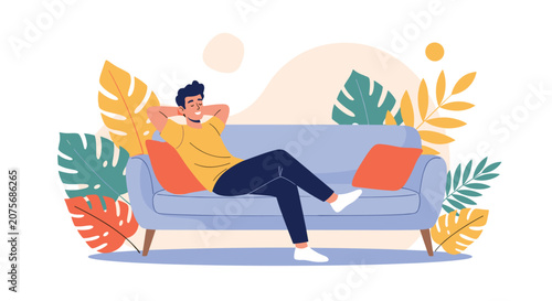 Casual young man relaxing on a comfortable sofa with hands behind his head surrounded by giant tropical leaves.