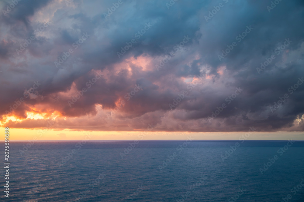Obraz premium Sky with bright orange clouds after sunset. Sky background.