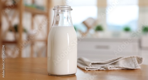 Bilde på lerret Bottle of fresh milk on wooden table in kitchen