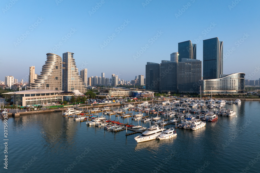 Fototapeta premium Qingdao Olympic Sailing Center modern architecture skyline with yachts docked at marina