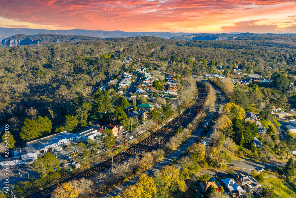 Obraz premium Aerial photograph of the regional train line running through the busy tourist town of Katoomba in the Blue Mountains in New South Wales, Australia