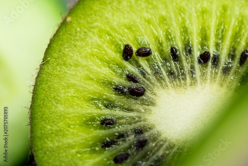 Fotografie Fresh green kiwi fruit slice in extreme macro detail perfect for healthy food advertising organic juice packaging and web banners