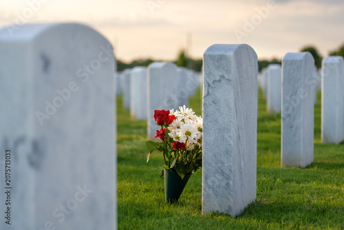 Army veteran cemetery with white headstones. Tombs of retired military soldiers. Memorial Day concept