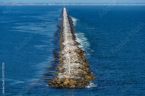 Canvas Print Breakwater seawall made of boulders built along Long Beach,California