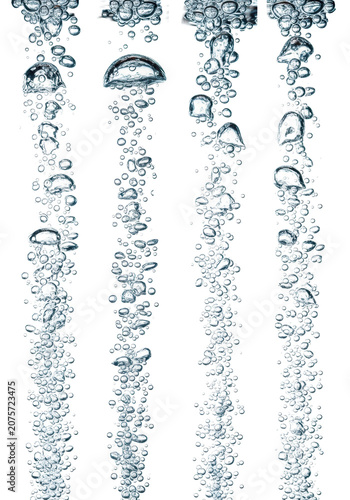 Four vertical streams of photorealistic carbonation bubbles rising in clear liquid on a white background with copy space. Concept for beverage advertising