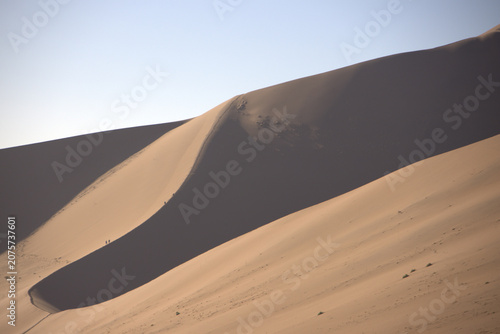 Massive Sand Dunes with Dramatic Light and Shadow at Sossusvlei Namib Desert, Tiny Hikers on Ridge
