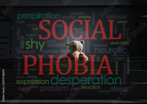 Social phobia. Lonely toy bear on stairs in darkness, double exposure with words