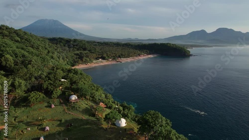 Aerial View of Virgin Beach Coastline with Green Cliffs, Blue Ocean and Volcanoes in Bali