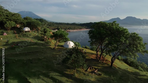 Aerial View of Virgin Beach Coastline with Green Cliffs, Blue Ocean and Volcanoes in Bali