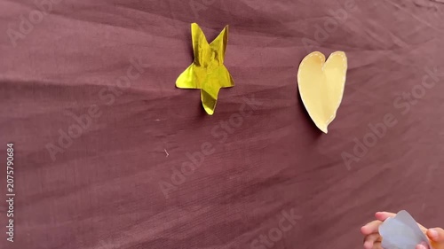 Putting heart shaped craft on fabric wall with hands during playful activity