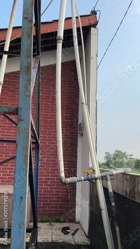 Inspecting Outdoor Plumbing and Brick Wall Area for Simple Maintenance