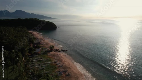 Aerial View of Virgin Beach Palm Forest, Ocean Horizon and Sun Reflection on Water in Bali