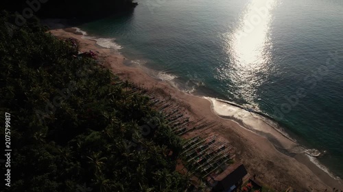 Aerial View of Virgin Beach Palm Forest, Ocean Horizon and Sun Reflection on Water in Bali