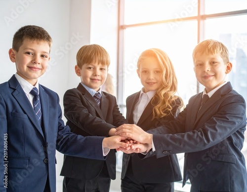 Kids in suits, hands together