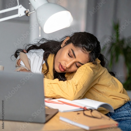 Exhausted student sleeping at desk