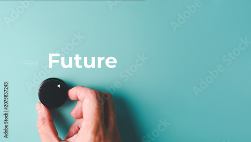 Photos A hand turns a black knob towards Future on a blue background, with Past faded to the left