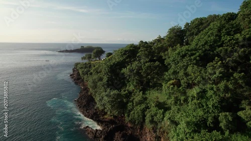 Aerial View of Tropical Forest Coastline, Rocky Island and Blue Ocean in Bali
