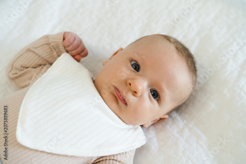 Tableau sur toile Portrait of a two to three month old baby with visible drool on lips