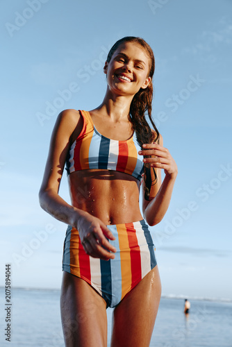 Cuadro en lienzo Woman beach summer swimsuit smiling running outdoors sunny athletic young woman