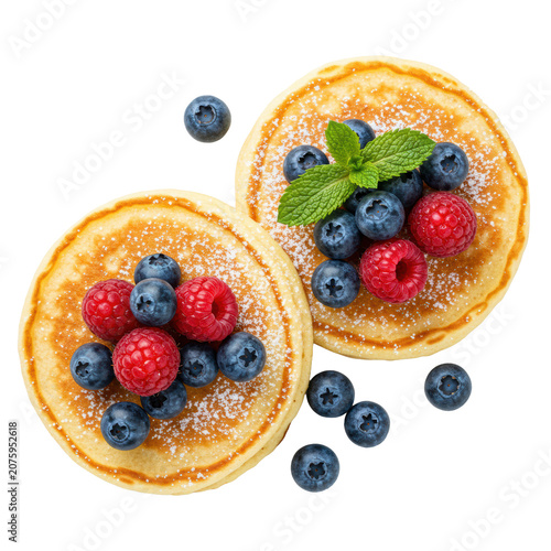 Overhead, photorealistic shot of two golden-brown fluffy buttermilk pancakes with powdered sugar, fresh berries, mint, on a transparent background with copy space, gourmet breakfast concept