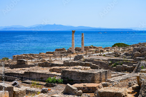 фотографія Ancient roman columns and ruins of Tharros archaeological site overlooking the G
