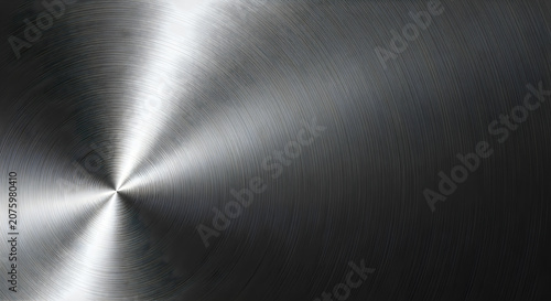 Brushed metallic surface featuring a circular pattern with high contrast lighting and a shiny silver texture for modern industrial designs