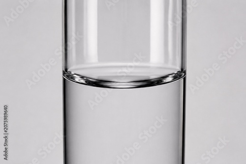 Clear water in a glass cylinder showing a concave surface.