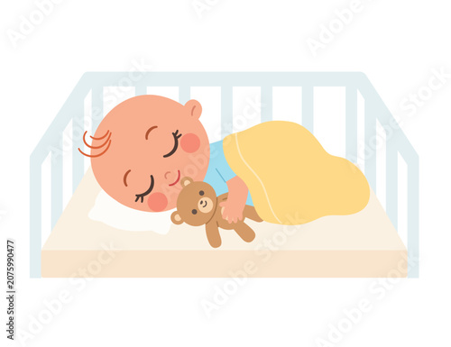 Cute little baby sleeping peacefully in a crib holding teddy bear on white background.