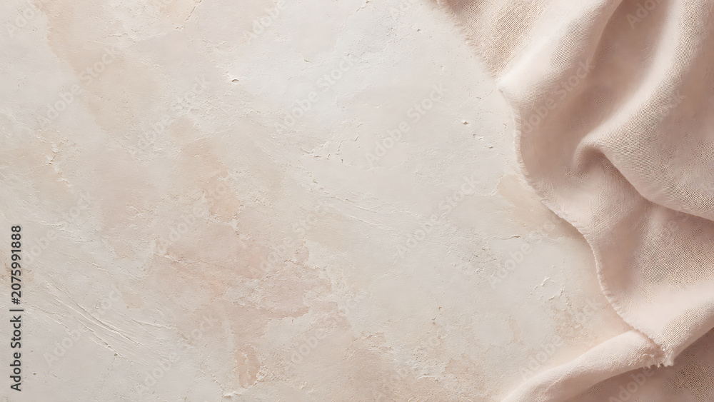 Fototapeta premium Beige fabric draped over a textured plaster surface, view