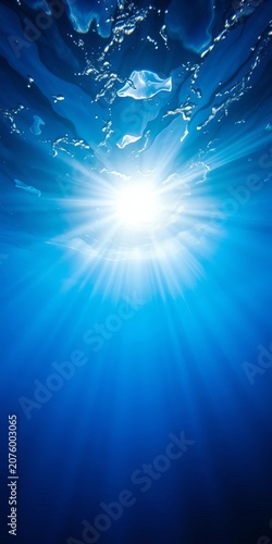 Dramatic underwater scene with sunbeams piercing through blue ocean water, peaceful, fish