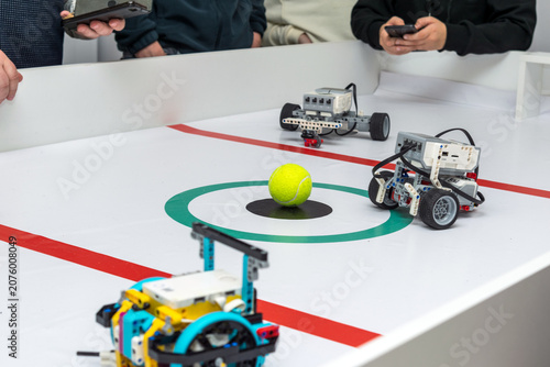 Photography Children controlling robots via smartphones during a robot soccer game